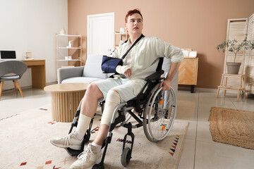 Fototapeta na wymiar Injured young man after accident in wheelchair at home