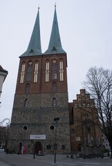 Berlin, Germany - Jan 21, 2024: Nikolai Quarter and St. Nicholas Church in Berlin. Cloudy winter day. Selective focus