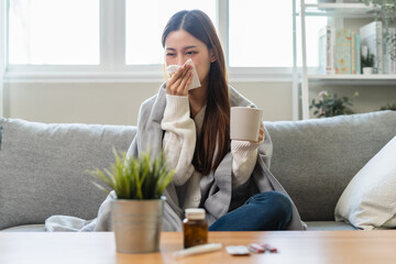 Seasonal sick concept. the young woman has a common cold and sneezing on the sofa.