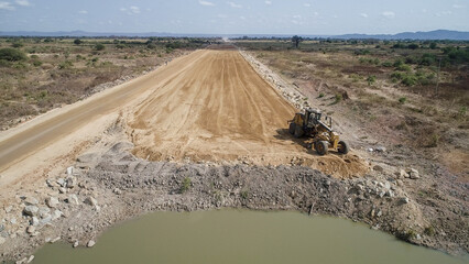 construction machines at works, dozer, roller machine, excavator, crawler rock drill machine, trucks, GPS grader