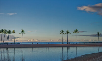 Coconut Palm Trees and Sand Fringing a Pacific Island Lagoon.