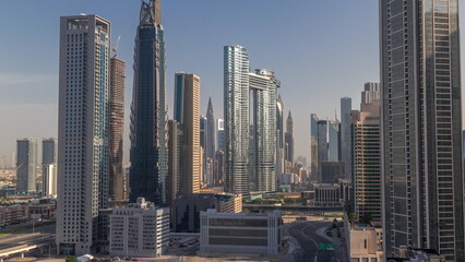 Fototapeta na wymiar Many towers and skyscrapers with traffic on streets in Dubai Downtown and financial district morning timelapse.
