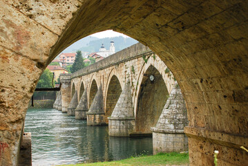View of Mehmed Paša Sokolović Bridge in Višegrad, Bosnia and Herzegovina. Unesco world heritage site. Bridge over the Drina river. - obrazy, fototapety, plakaty