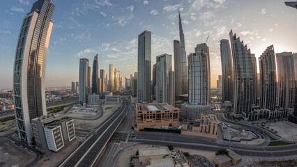 Naklejka na ściany i meble Aerial panorama of Dubai Downtown skyline with many towers night to day timelapse.