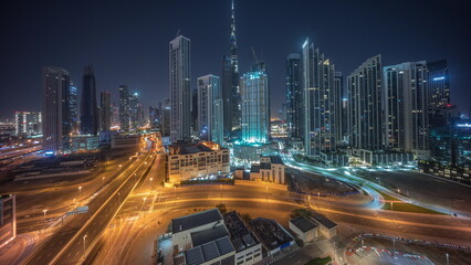 Fototapeta na wymiar Aerial panoramic view of Dubai Downtown skyline with many towers all night timelapse.