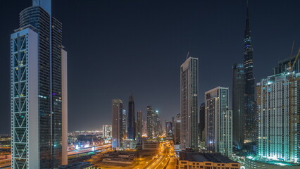 Fototapeta na wymiar Aerial view of Dubai Downtown skyline with many towers all night timelapse.