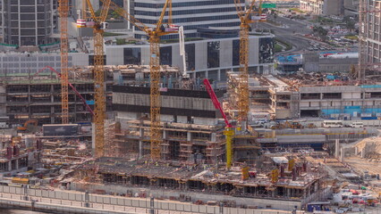 Large construction site with many working cranes timelapse.