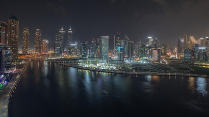 Fototapeta na wymiar Panorama showing aerial view to Dubai Business Bay and Downtown with the various skyscrapers and towers night timelapse