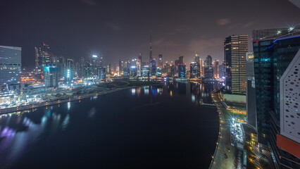 Aerial view to Dubai Business Bay and Downtown with the various skyscrapers and towers all night timelapse