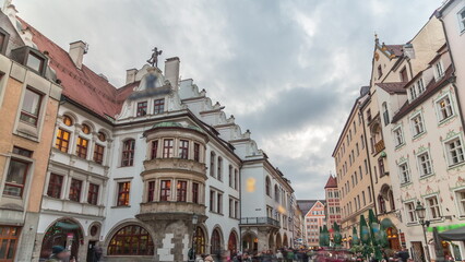 Fototapeta na wymiar Cityscape with bier houses and restaurants outdoors on Platzl timelapse in Munich, Bayern, Germany.