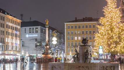 Obraz premium Fish Fountain, Fischbrunnen in front of the New New Town Hall at Marienplatz night timelapse in Munich, Germany