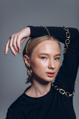 Close up glamour portrait of blondie beautiful young girl in necklace and earings, fashion jewellery