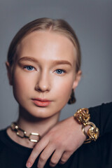 Close up glamour portrait of blondie beautiful young girl in necklace and earings, fashion jewellery