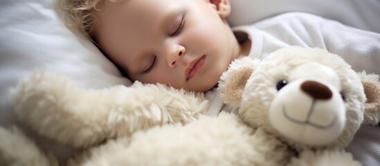 Cute child sleeping with teddy bear on bed at home