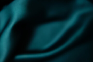 Emerald green silk or satin, draped fabric, elegant background. Beautiful wavy space for design...