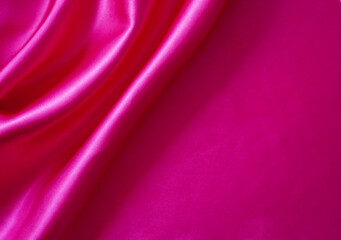 Pink silk or satin background, wavy, elegant and elegant. Close-up, background. Space for...
