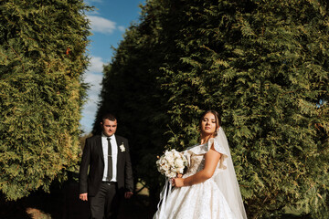 The moment of the first meeting of the bride and groom with a wedding bouquet, the bride is waiting...