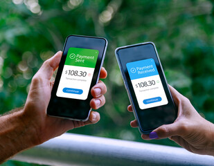 Two smartphones held by a woman and a man showing sending and receiving payments through a digital...
