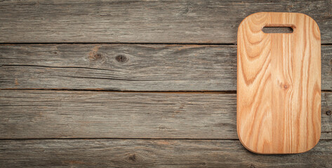 Wooden cutting board on a wooden background. top view. copy space