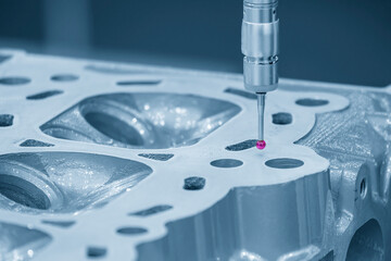 The multi axis CMM machine measuring the aluminum cylinder head parts .