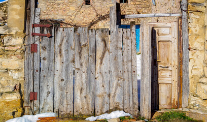 Aantique aged wooden door of a European rural village.
