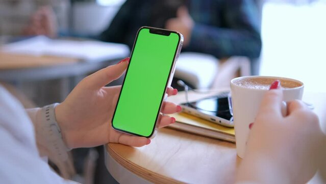 Businesswoman, hands or green screen phone in coffee shop, restaurant or cafe on social media app or calendar management. worker employee or mobile technology mockup of office logo on lunch break 4K