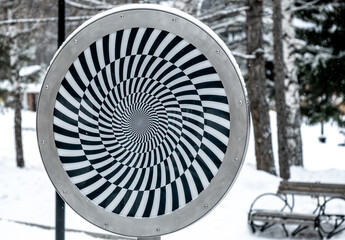 The optical illusion is a spiral of black and white stripes.
