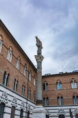 Fototapeta na wymiar She-wolf breastfeeding Romulus and Remusat statue next to the Duomo in Siena, Italy