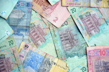 Fototapeta premium Processed collage of Ukrainian Hryvnia UAH bills banknotes texture. Background for banner