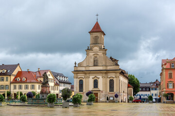 Fototapeta na wymiar Catholic Church and Market Square (Marktplatz) in Ludwigsburg, Germany, cloudy sky in background.