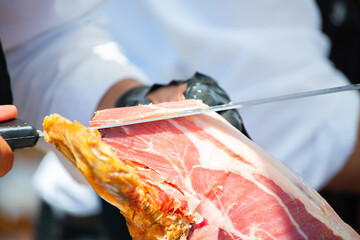 Ham cutting master, professional knife master, Cortador de jamon, man cutting jamon ham placed in a stand - 736258541