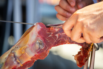 Ham cutting master, professional knife master, Cortador de jamon, man cutting jamon ham placed in a...