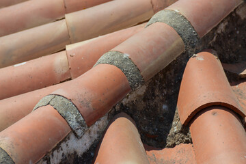 Traditional old Spanish ceramic roof tiles on a building, characteristic elements of Mediterranean architecture