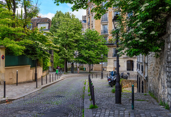 Cozy street in quarter Montmartre in Paris, France. Cozy cityscape of Paris. Architecture and landmarks of Paris. - 736259933