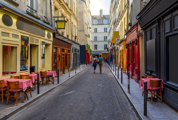 Cozy street with tables of cafe  in Paris, France. Cityscape of Paris. Architecture and landmarks of Paris - 736263394