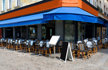 Typical view of the Parisian street with tables with tables of cafe in Paris, France. Architecture and landmark of Paris. Cozy Paris cityscape - 736265197
