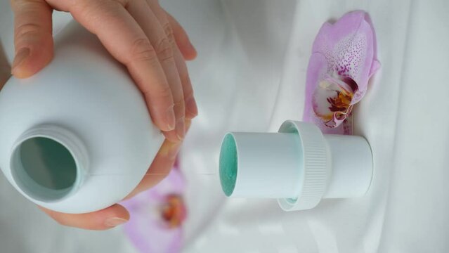 The process of pouring natural eco gel liquid laundry detergent from the bottle into the cap, vertical shoot