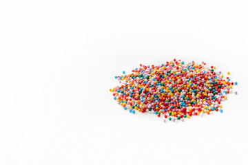 A bunch of small colorful sugar confetti balls for decorating desserts. Flat layout. Copy space