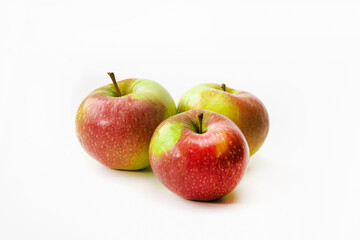 Three red-green ripe apples on a white isolated background