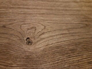The wooden background features a rich, textured surface, showcasing the intricate patterns of wood grain.