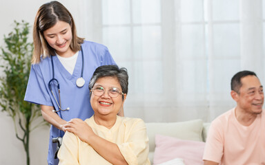 Fototapeta premium Selective focus Asian female nurse, doctor wearing uniform, smiling with happiness and warmth, taking care senior healthy wellbeing old aging woman on wheelchair. Nursing home, Aging Society Concept.