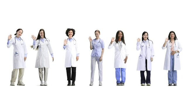 A group of doctors, in full height, on a white background, waving their hands