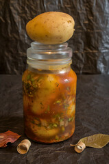 glass jar full of raw potatoes to marinate