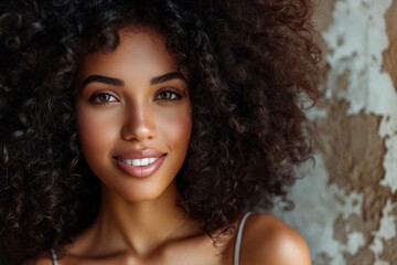 Portrait of smiling African American woman with wavy hairstyle showcasing beautiful dreamy afro hair