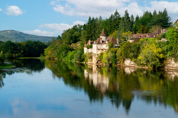 River Dordogne in Meyronne, Lot, France with a chateau reflected in the river