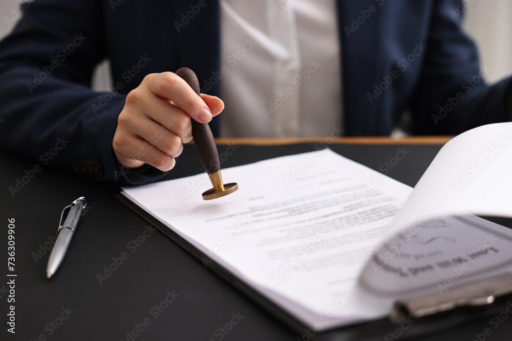 Poster Notary sealing document at table in office, closeup