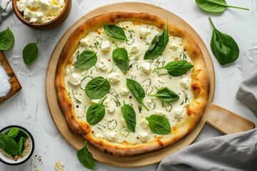 Top down shot of a white pizza with ricotta and spinach
