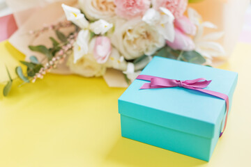 Beautiful bouquet and blue gift box