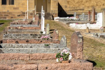 cemetery graves and cross in a graveyard in a church in australia