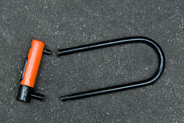 bike u-lock cut in half (cycle theft concept) heavy duty lock for bicycle in urban setting (crime,...